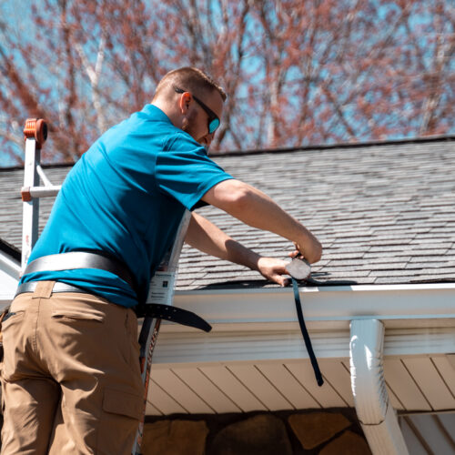 Project Manager Evaluating Roof & Gutters